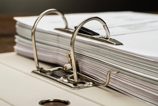 A large binder, representing how thorough documentation can influence a workplace harassment case.
