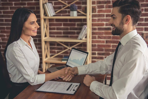 An employee and employer discussing wage and hour benefits that may not be provided to independent contractors.