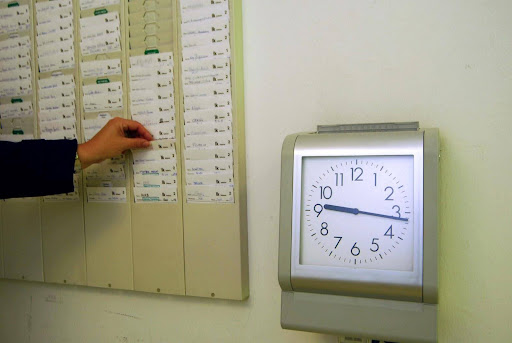 Employee using a time clock for wage and hour tracking