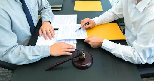 A corporate client reviewing the results of a workplace harassment investigation in an attorney’s office. 