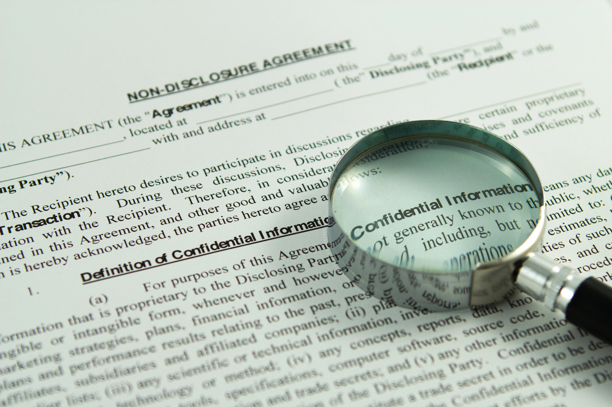 Image of a non-disclosure agreement document under review, illustrating how confidentiality terms play a key role in resolving business disputes and managing sensitive information.