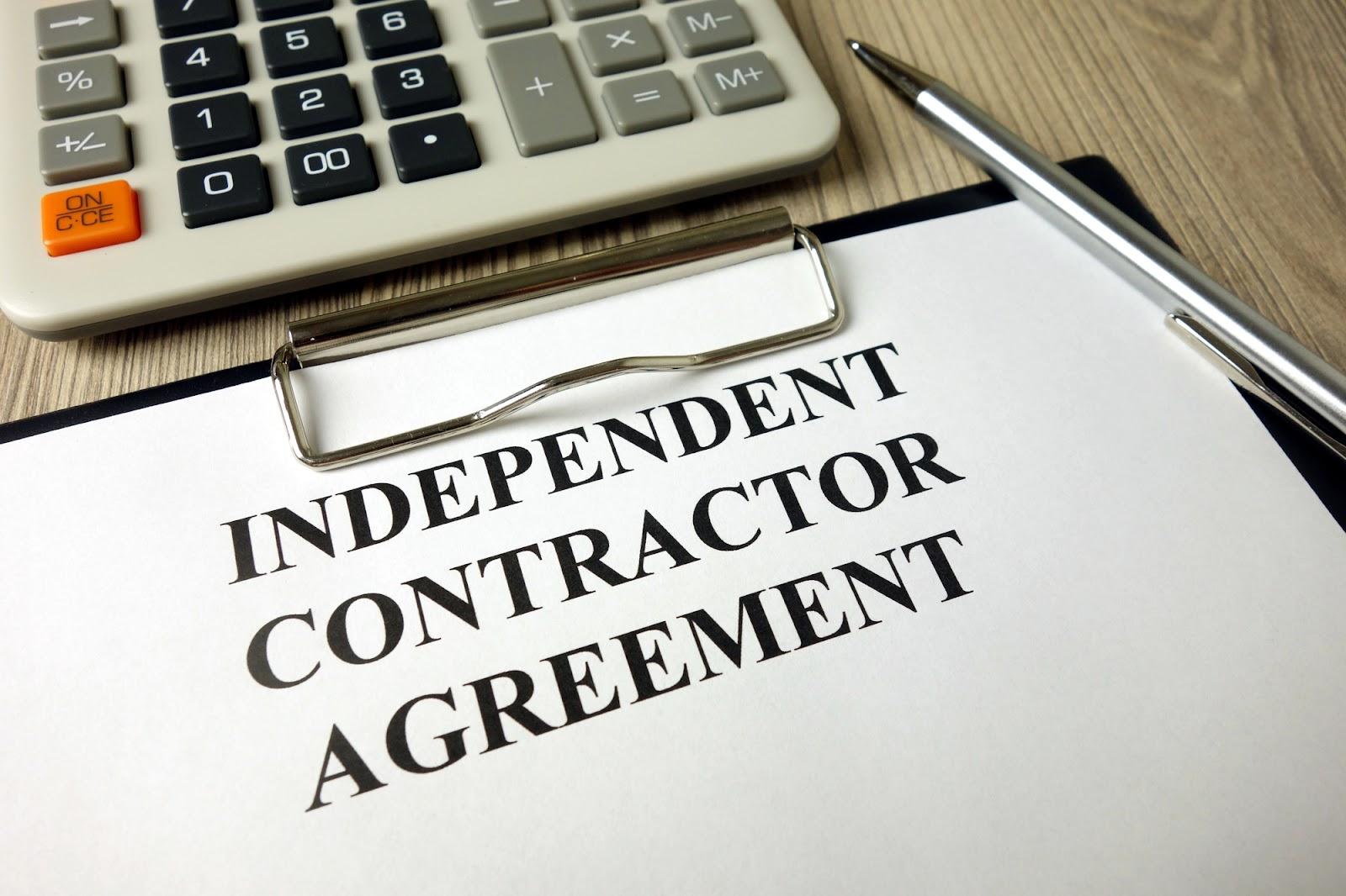 An independent contractor agreement on a clipboard on a desk; business litigation on gig economy platforms may benefit from the insight of an attorney.