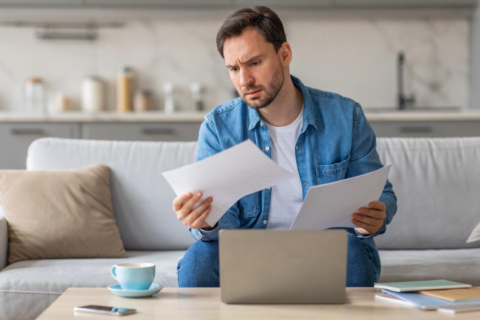 Concerned business owner reviewing employee complaints about potential wage violations.