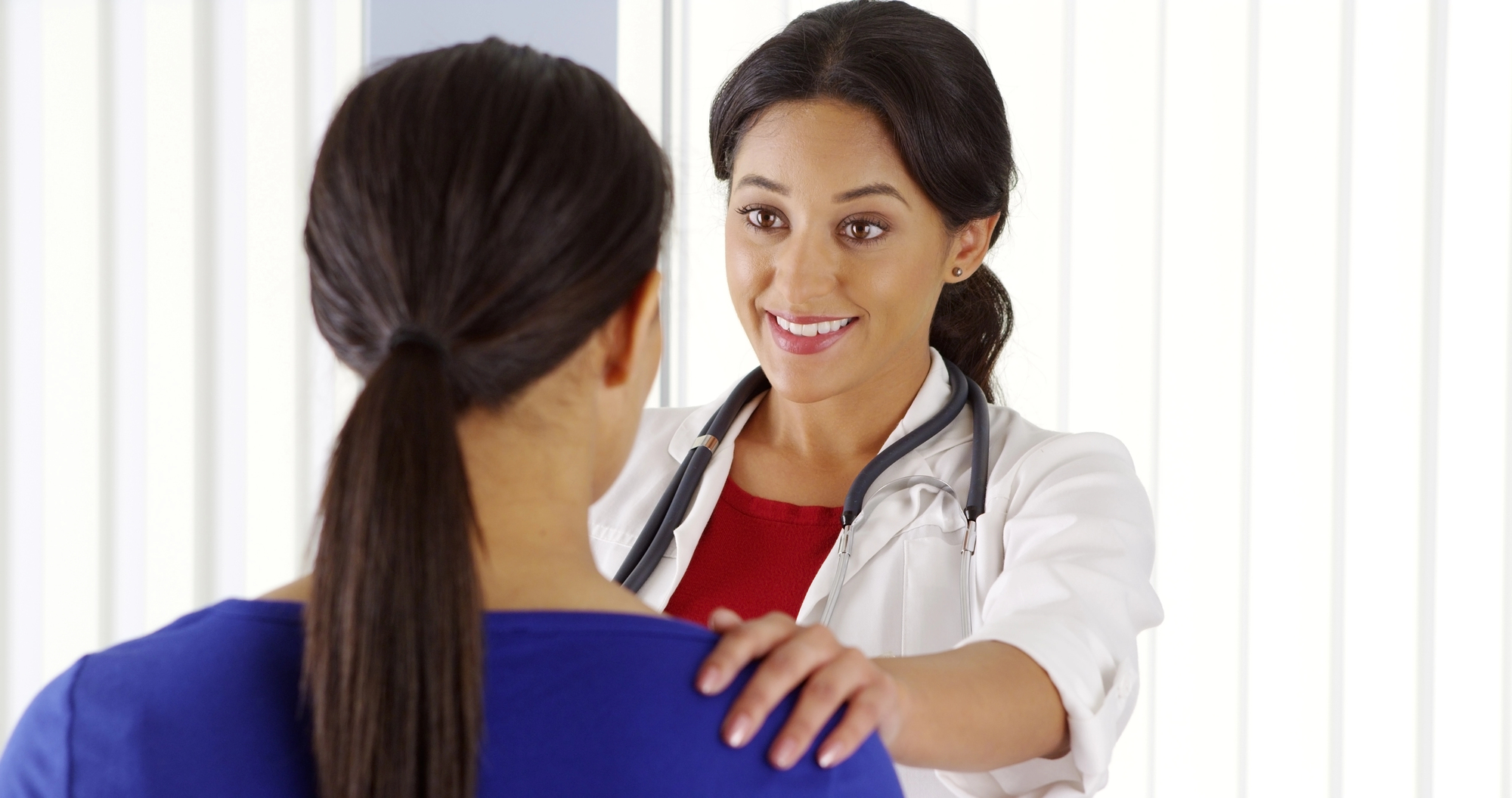 Healthcare professional consulting with a patient, reflecting real-world healthcare workplace dynamics and the importance of wage and hour compliance in the healthcare industry.